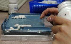 Pharmacist counting pills into a tray at Amazon PillPack