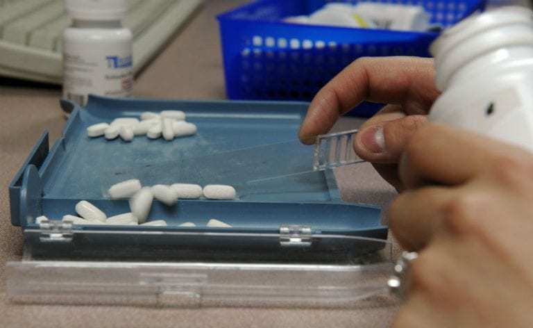 Pharmacist counting pills into a tray at Amazon PillPack