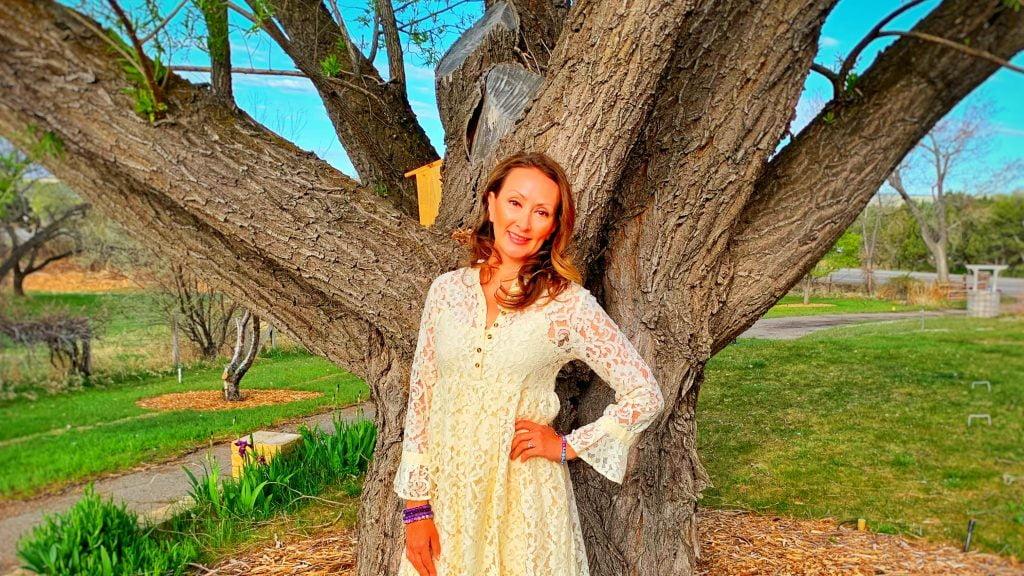 Adriana Monique Alvarez Standing by a tree