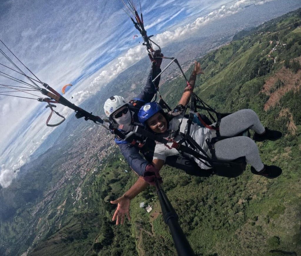 Issia Lee paragliding during travel in Colombia