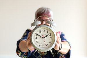 Journalist & PR consultant Fiona Scott holding an old-fashioned alarm clock