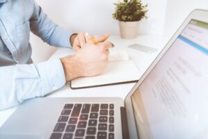 open laptop and a man in a business setup