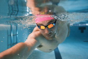 man swimming in goggles